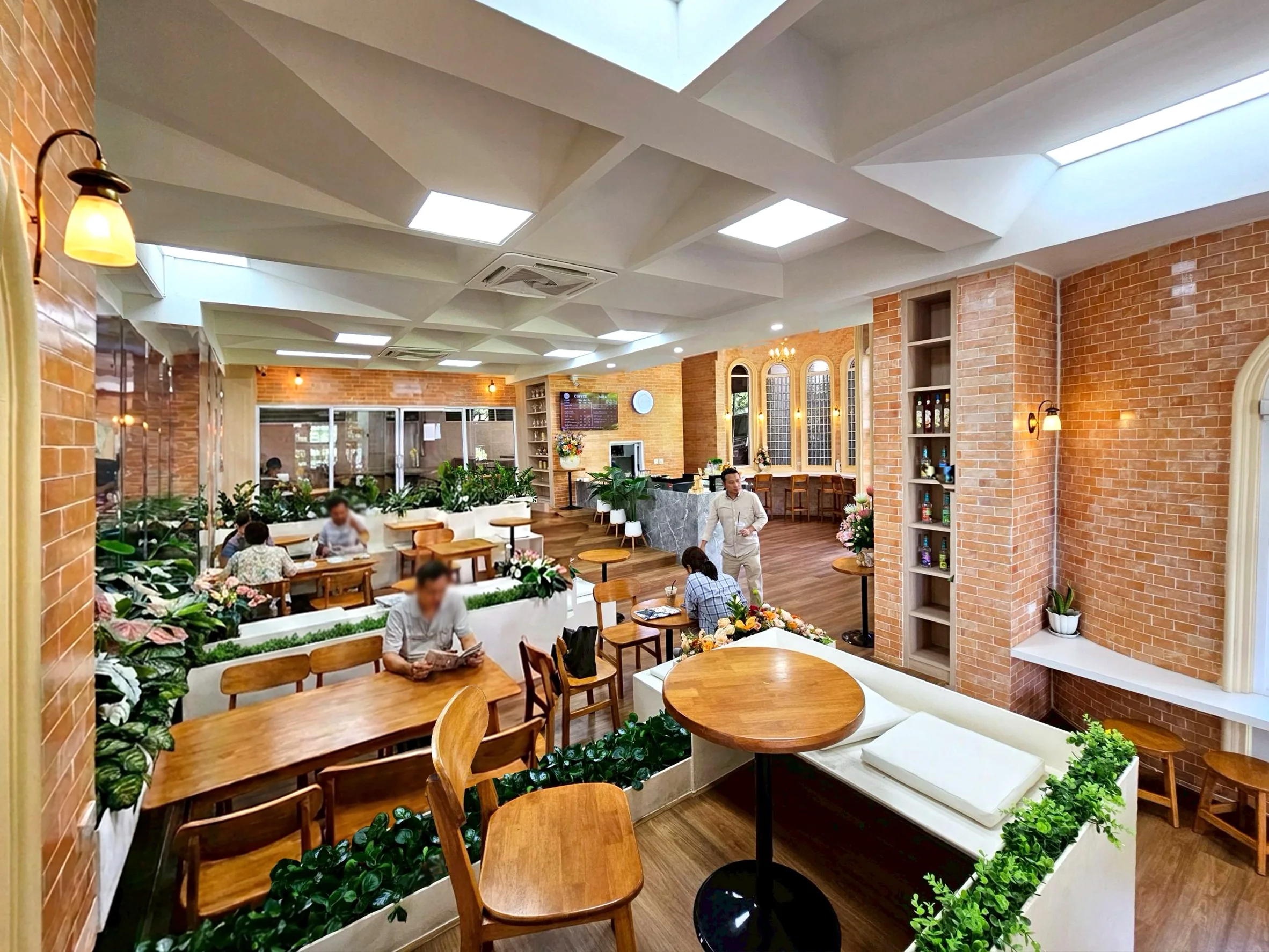 A varied seating landscape, planting and warm materials support different modes of gathering.