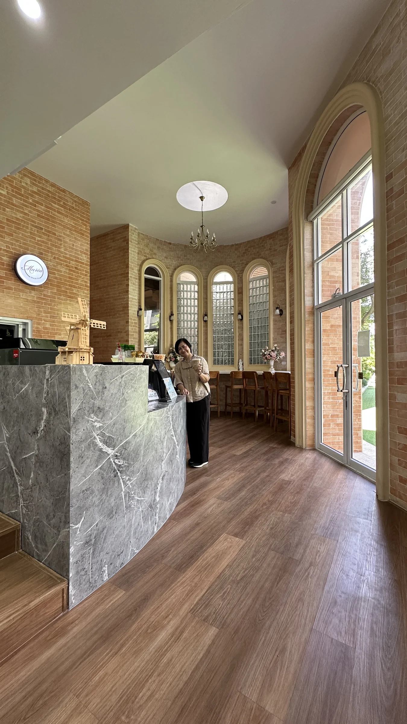 Arched openings, glass blocks and a curved counter define a welcoming threshold within the school.